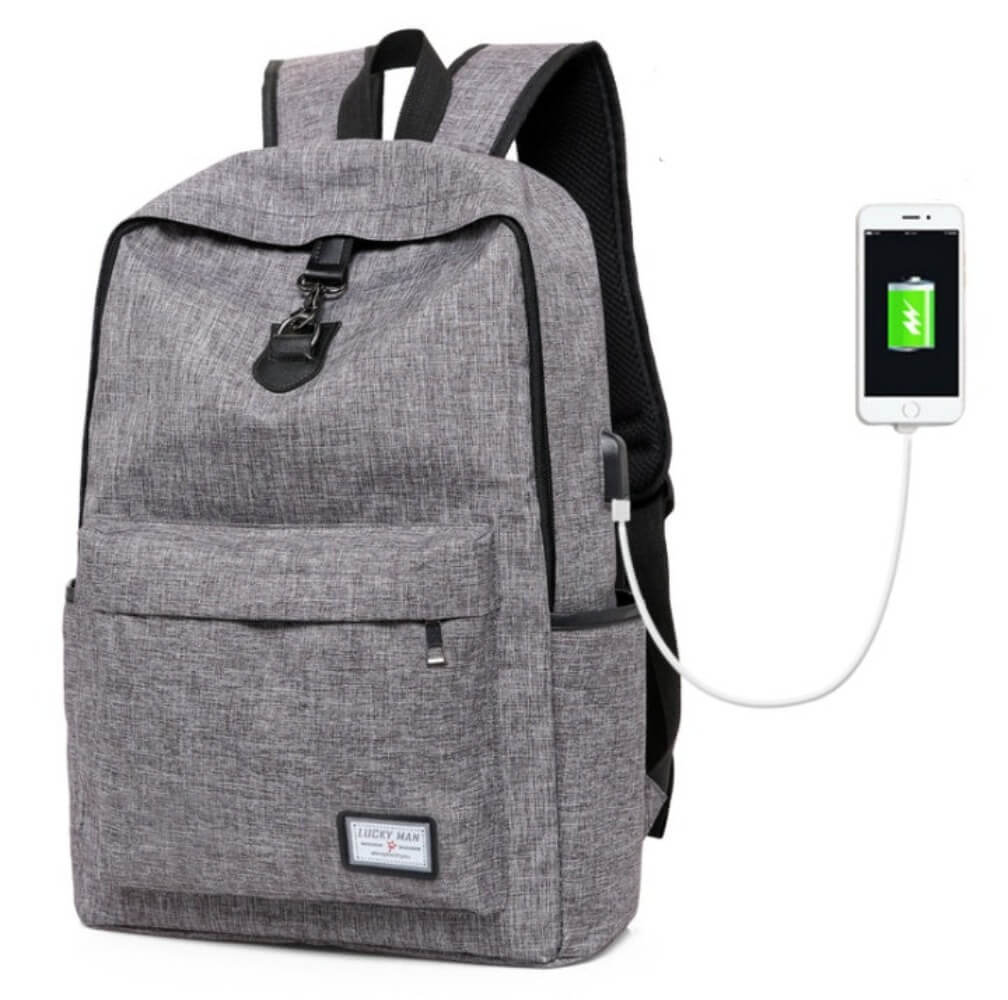The anti-theft backpack with a cord attached, charging a smart phone.