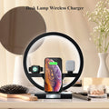 The wireless charger table lamp standing on an inside table accompanied by a hair brush, vase and flowers, mirror and various other utensils and ornaments.  