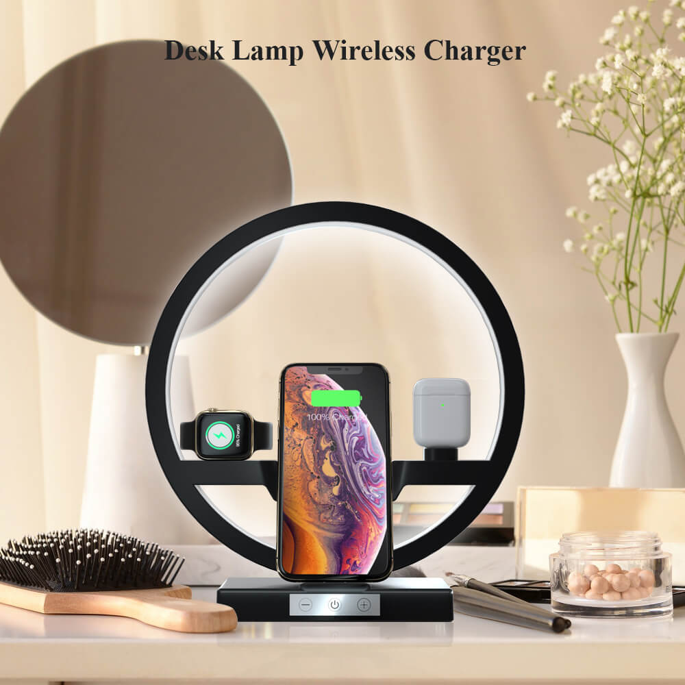 The wireless charger table lamp standing on an inside table accompanied by a hair brush, vase and flowers, mirror and various other utensils and ornaments.  